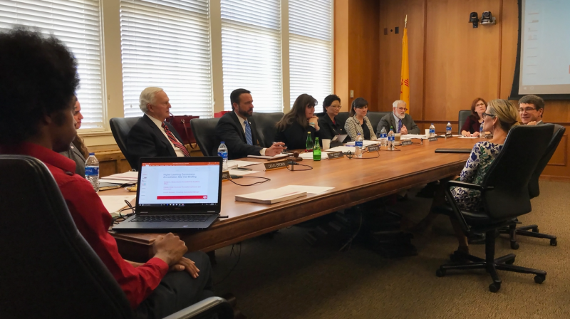 Staff gathered around conference table for meeting